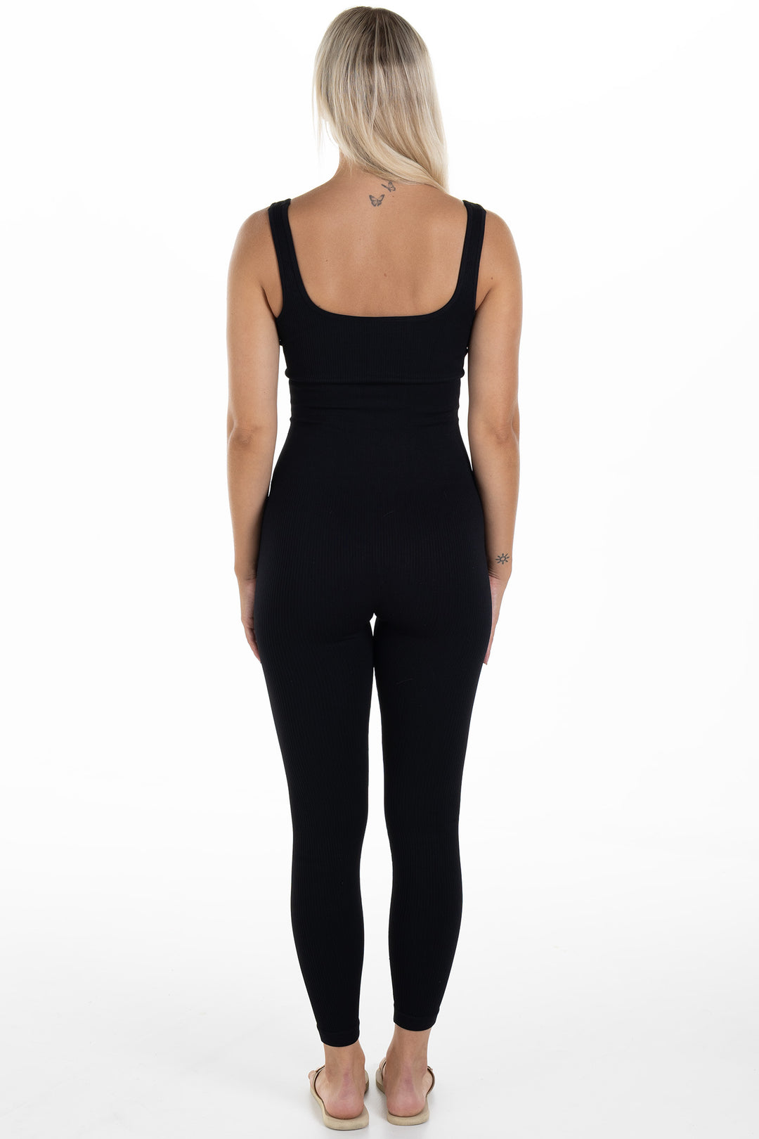 Woman in Black Ribbed Jumpsuit Artus Back