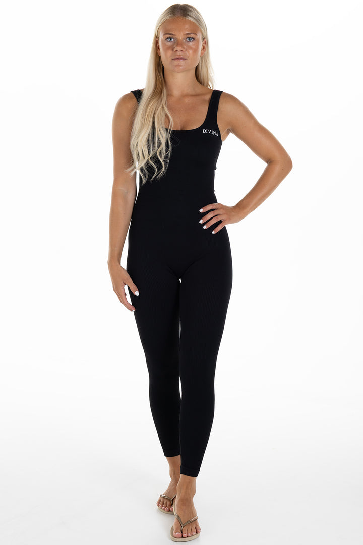 Woman in Black Ribbed Jumpsuit Artus Front