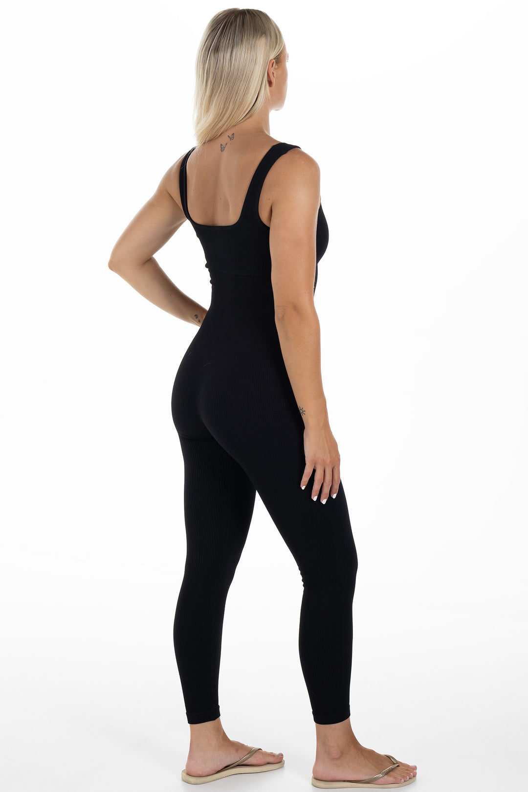 Woman in Black Ribbed Jumpsuit Artus Side