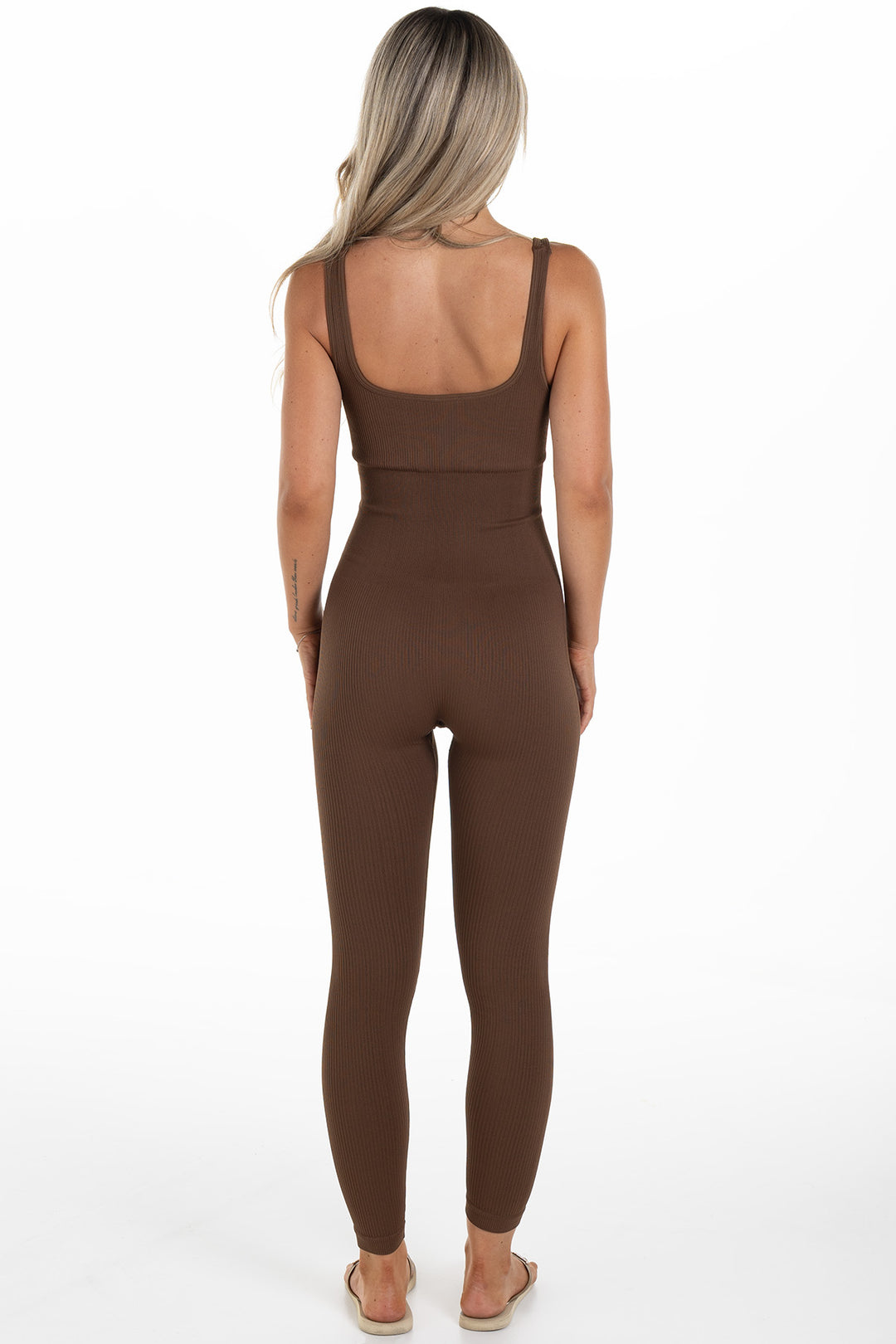 Woman in Brown Ribbed Jumpsuit Back
